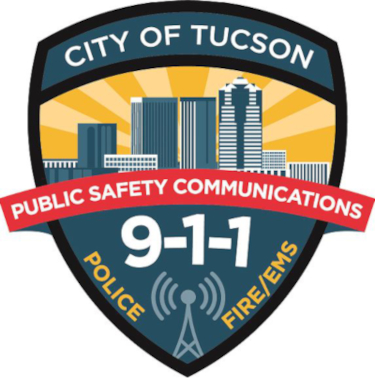 Public Safety Communications Blue and Yellow Badge Logo says City of Tucson Public Safety Communications 9-1-1 Police Fire and EMS