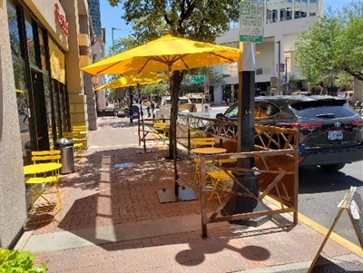 Extended patio at Bombole restaurant with yellow umbrellas 